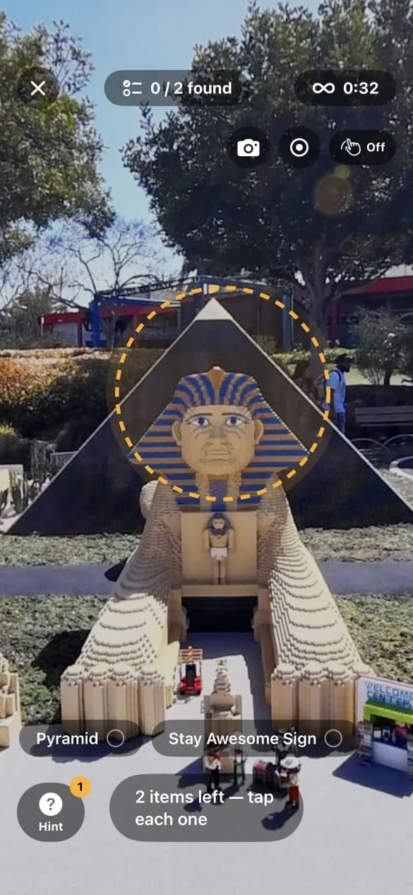 A Find round at a Lego park: a sphinx and pyramid circled by the hint ring, with Pyramid and Stay Awesome Sign listed as the items to find