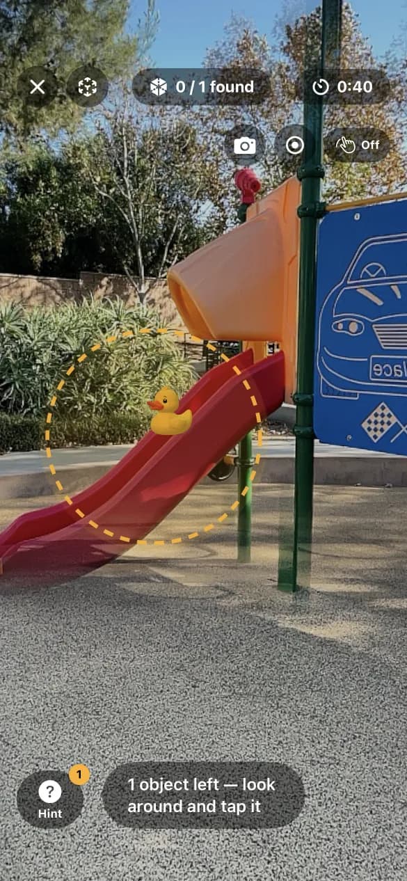 A Spot round in play: a real 360° playground with a rubber duck sitting on the slide, circled by the hint ring, 0 of 1 found and 40 seconds left